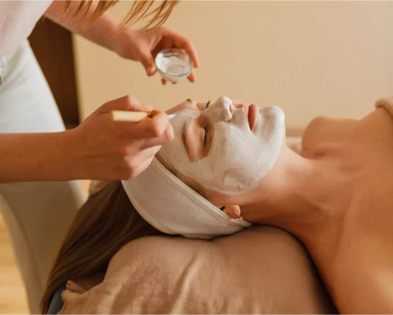 Practitioner performing a gentle facial massage